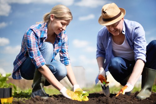 Gardener planting flowers in Heston garden